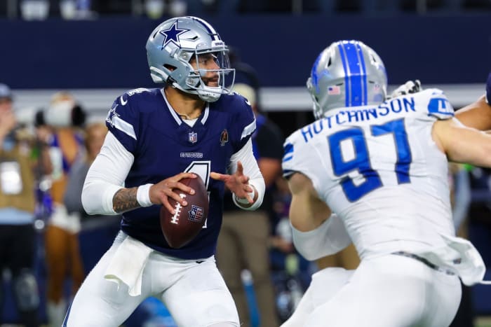 Dallas Cowboys quarterback Dak Prescott (4) throws as Detroit Lions defensive end Aidan Hutchinson (97) rushes during the second half at AT&T Stadium.